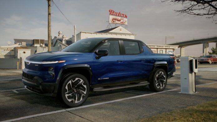 The Silverado EV parks near a charging unit outside Bahrs Landin